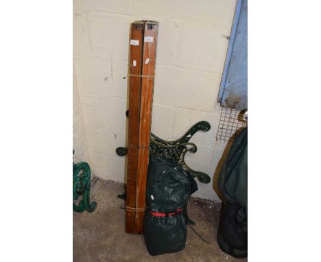 Cast iron bench ends together with slats and cover