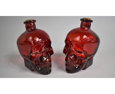 Two Ruby Glass Novelty Decanters in the Form of Skulls, 17cm high 