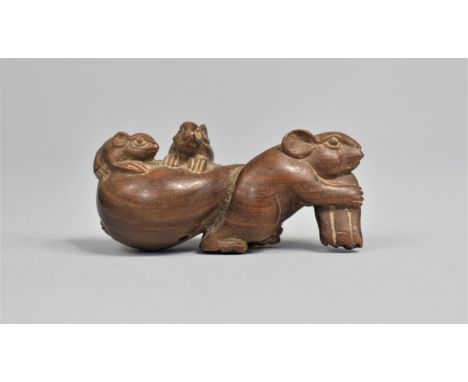 A Carved Wooden Netsuke in the Form of a Mouse Pulling Sack with Two Young Riding, Signed to Base, 5.5cm long 