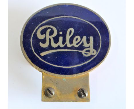 A Riley Motor-Car Badge Finished in lacquered brass with dark blue enamel in an ovoid shape. 8-cms high. 