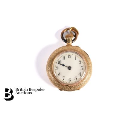 18ct Yellow gold open faced pocket watch, having a floral chased back with enamel cameo depicting a girl with a dove descendi