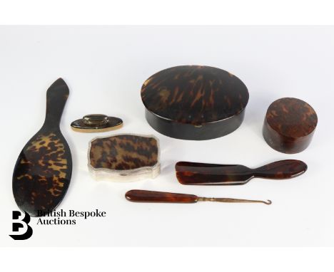 A late Victorian silver gilt and tortoiseshell manicure set with implements, hand mirror (mirror missing), shoe horn, button 