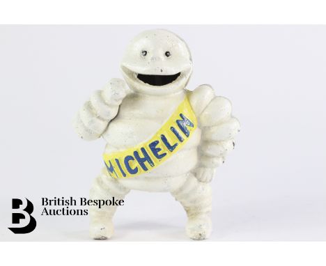 A cast iron money box depicting Monsieur Bibbendum, the Michelin Tyres mascot, with slot to insert copper 1d coins through hi