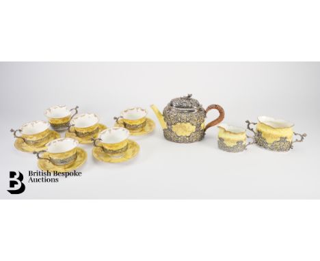 Late Victorian silver-mounted Staffordshire tea service to include: six cups and five saucers, with a silver clad milk jug, s