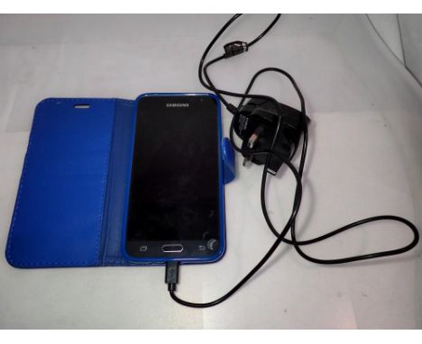 Samsung smartphone with wallet case and charger, working at lotting. UK P&amp;P Group 1 (£16+VAT for the first lot and £2+VAT
