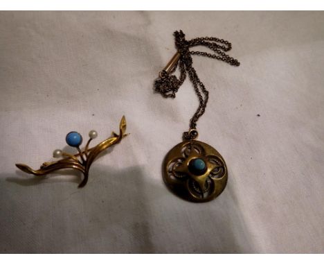 A yellow metal stone set pendant necklace and a yellow metal brooch set with pearls and a blue stone. UK P&amp;P Group 1 (£16