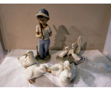 Four Nao geese and a damaged Lladro figurine. Largest H: 22 cm. Not available for in-house P&amp;P 