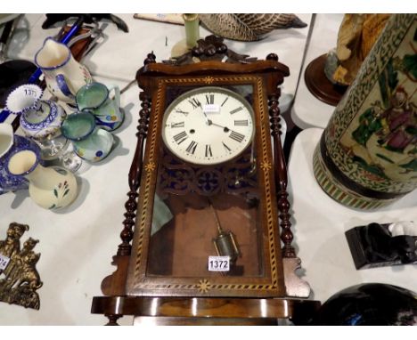 Inlaid chiming wall clock with faux mercury pendulum. Not available for in-house P&amp;P 