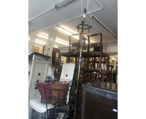 A wrought iron lamp, mirror and a stick stand