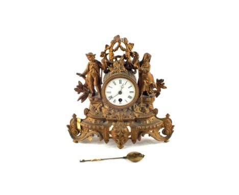 A gilt spelter figure mounted mantel clock
