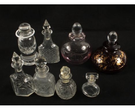 A ruby glass scent bottle and seven others