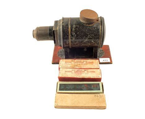 A tin plate magic lantern and three boxes of coloured childrens slides