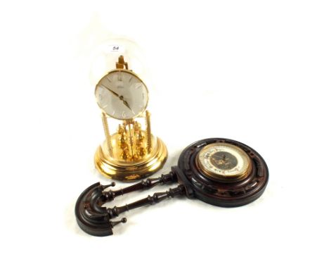 A dome clock and a carved Mahogany barometer