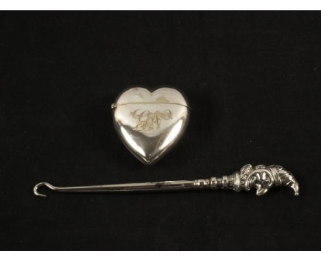 A Silver Mr Punch button hook, Birmingham 1906 and a late 19th Century Silver plated heart shaped vesta case