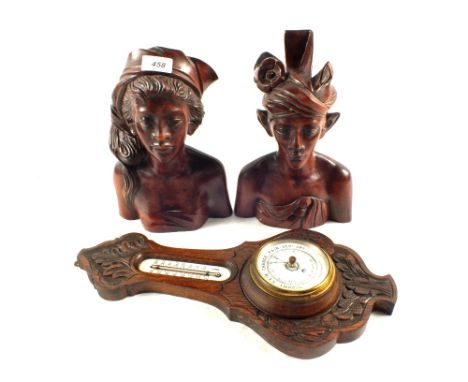 A pair of Balinese hardwood busts and a carved Oak barometer