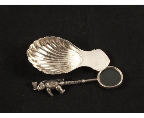 A magnifying glass with teddy bear handle and moveable limbs, clasp marked 925 and a modern Silver shell caddy spoon, Sheffie