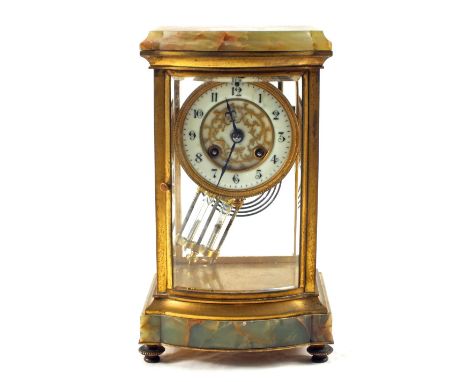 An Onyx and gilt metal glass sided mantel clock