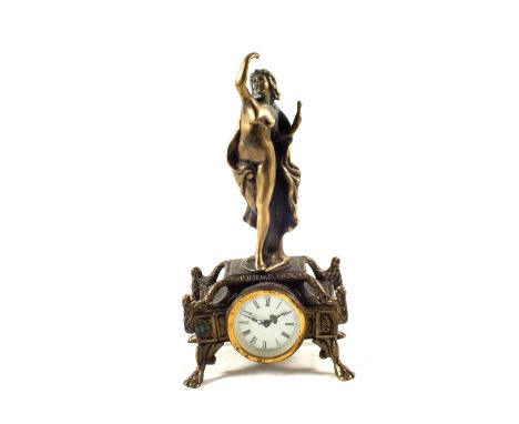 An Edwardian Brass mantel clock with standing lady mount