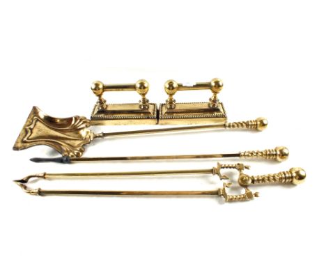 A set of three Art Nouveau period Brass fire irons with barley twist handles and a pair of Brass fire dogs