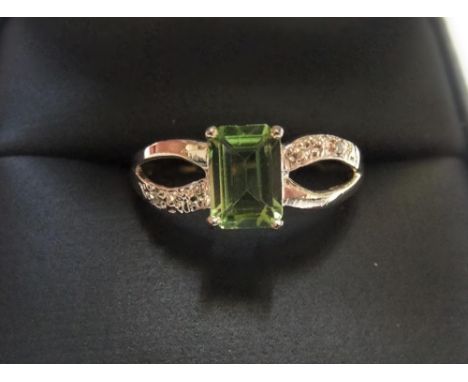 9ct yellow imported gold ring with octagon cut peridot & with small set diamonds to both shouldersApprox 1.3 grams gross,    