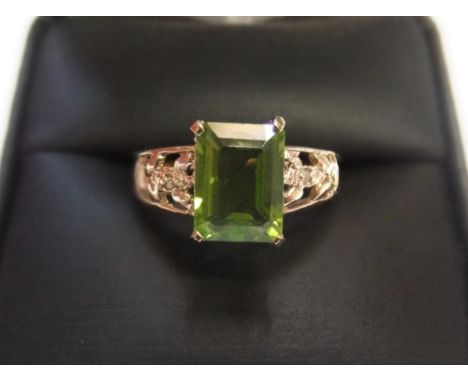 9ct yellow gold imported ring with a large Peridot stone with small diamonds to shouldersApprox 1.8 grams gross,             