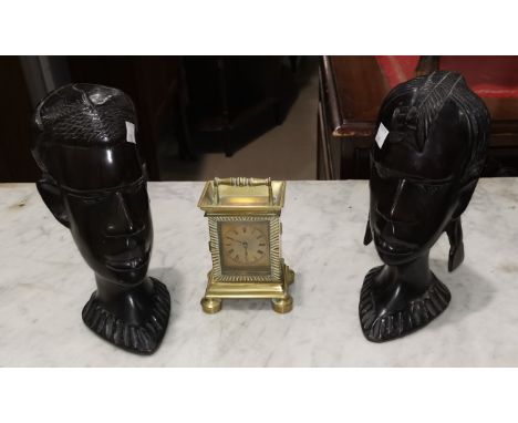 A pair of African carved hardwood busts, 21 cm; a quantity of table linen; a carriage clock  with 19th century watch movement