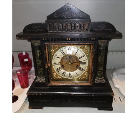 A mantel clock in ebonised wood architectural case, with brass dial and striking movement; an early 20th century mahogany ser