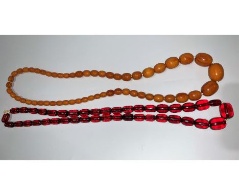 A butterscotch amber coloured necklace; a cherry amber item; etc.butterscotch 58gmcherry 54gm 