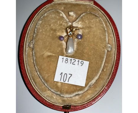 A diamond and freshwater pearl pendant; a cross pendant on chain; a similar stamped '9K' 