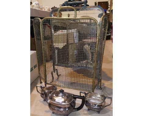 A silver plated 3 piece tea service; a mirrored firescreen; a brass fireguard