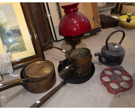 A reproduction brass oil lamp; a selection of pewter; cast iron and copper pans; etc. 