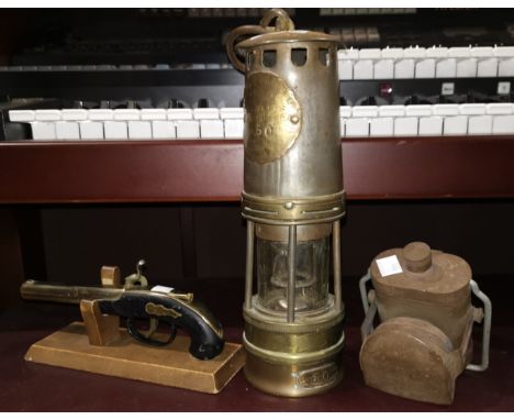 An early 20th C brass miner's lamp with steel bonnet 'Woods Improved Lamp', a vintage signal / bike lamp, a replica muff pist