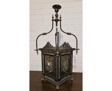 An Edwardian brass hall light fitting with coloured and leaded glass panels 