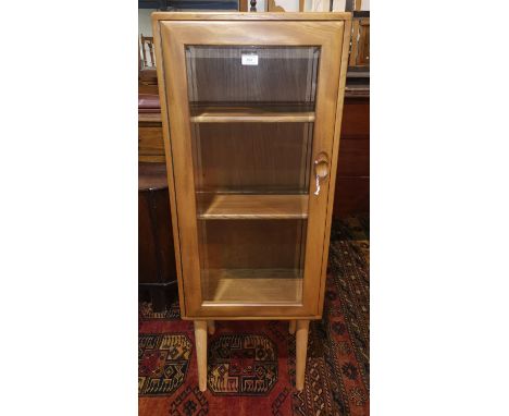 An Ercol light elm display cabinet on later legs 