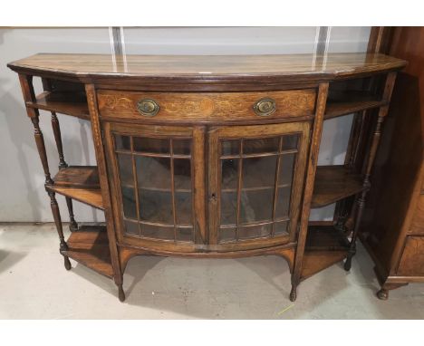 An Edwardian rosewood cabinet with bow front, double glazed single door, shelves to either side, height 41", length 60" 