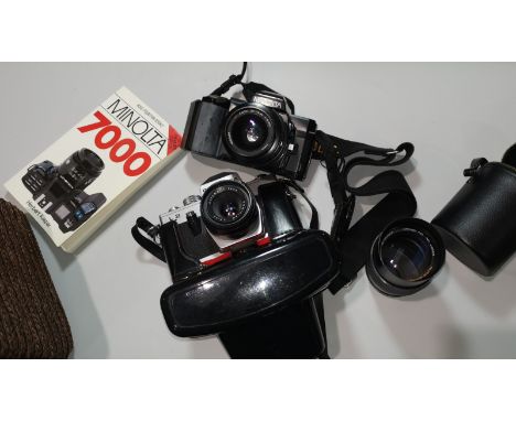 A Minolta 7000 SLR camera with 35-70 mm lens; a Chinon 135 mm lens; a Pentacon camera; etc. 