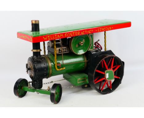 A large static scratch built model of a steam traction engine. The large scale metal model measures approximately 56cms (L) x