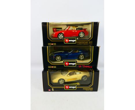 Bburago - Three boxed Bburago 1:18 scale diecast model cars. Lot consists of #3039 Ferrari 348tb; #3090 Porsche 911 Carrera C