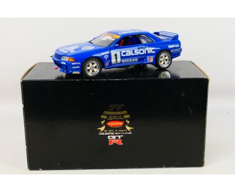 Kyosho - A boxed Kyosho #7002-12000 1:18 scale Calsonic Skyline GTR. The model appears to be in Mint condition, contained wit