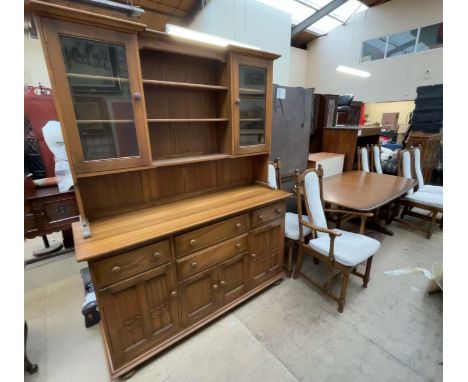 An Ercol dining suite comprising an extending dining table, six chairs and a dresser