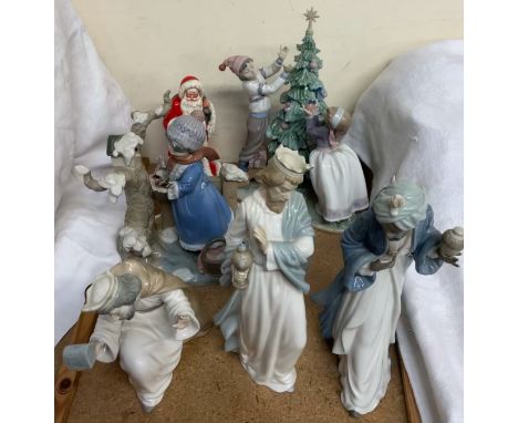 A Lladro figure group of children dressing a Christmas tree, together with another Lladro figure group, three Nao figures of 