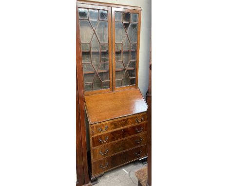 A 20th century mahogany bureau bookcase, the caddy top above a pair of glazed doors, the base with a sloping fall enclosing d