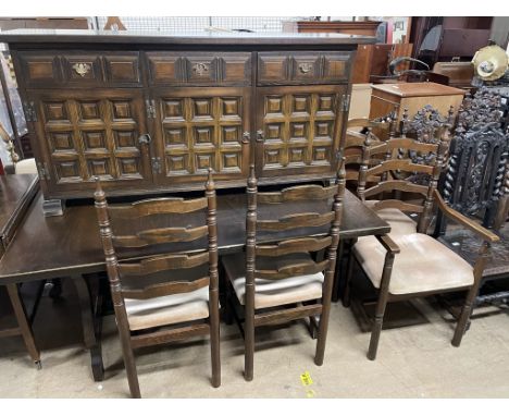 A 20th century oak dining table, together with a set of six ladder back dining chairs and a sideboard