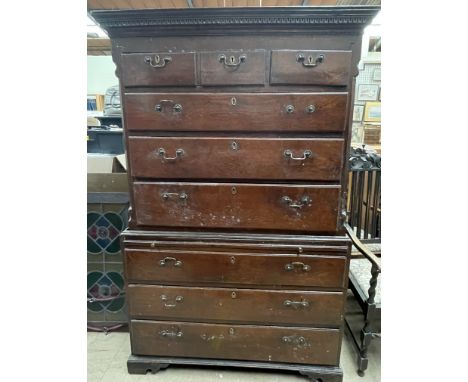 A George III oak chest on chest, with a moulded dentil cornice above three short drawers and three long drawers, the base wit