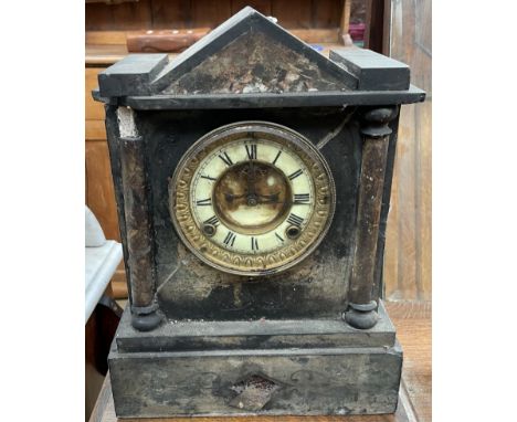 A black slate mantle clock of architectural form