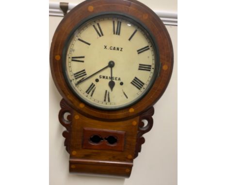 A Victorian walnut drop dial wall clock, the circular enamel dial with Roman numerals inscribed X. Ganz Swansea, 