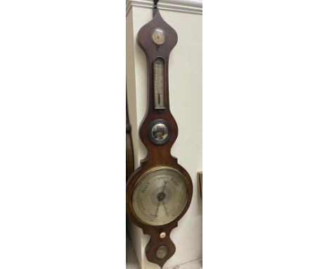 A Victorian mahogany onion topped banjo barometer, with an hydrometer, alcohol thermometer, convex mirror, silvered dial and 