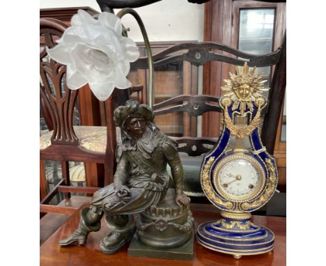 A Louis XV style clock with a sun surmount together with a Cavalier table lamp