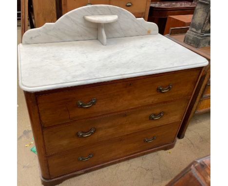 A Victorian marble topped mahogany wash stand / chest, the marble top with a raised back and shelf above three long drawers o