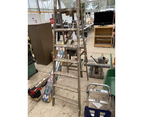 A VINTAGE WOODEN SET OF SEVEN RUNG FOLDING STEP LADDERS 